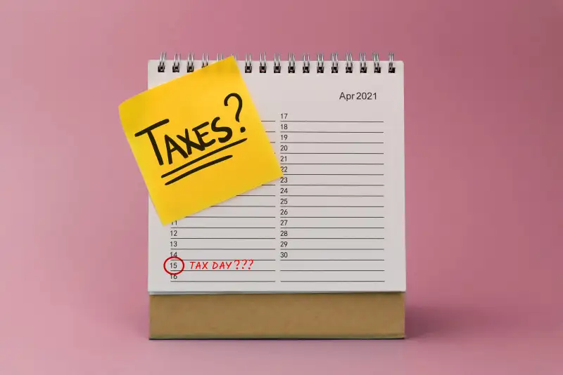 Photo of an April 2021 calendar with a post-it that says  Taxes?