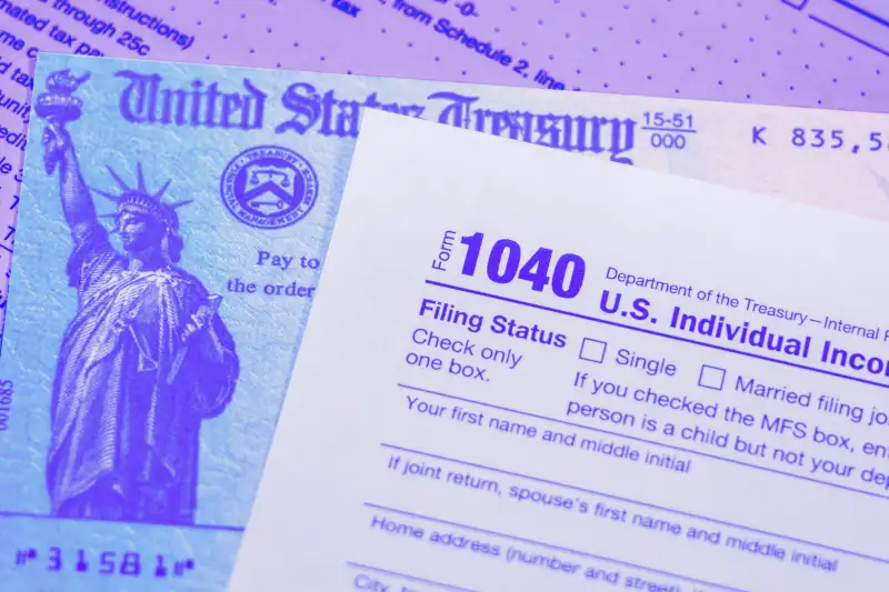 Photograph of a stimulus check under a 1040 tax form