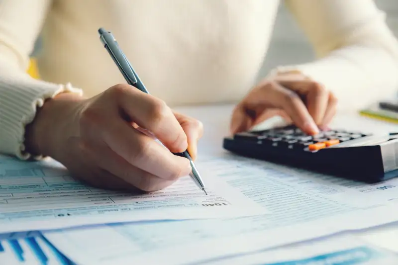 Closeup of a woman filling out an Individual Income Tax Return