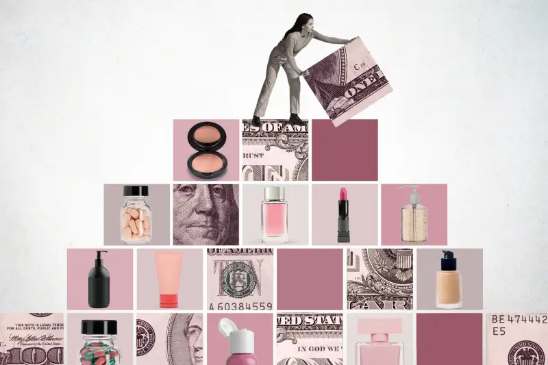 Woman lifting the final block on top of a pyramid made out of money and cosmetic products.