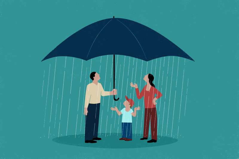 A family is under a raining umbrella.