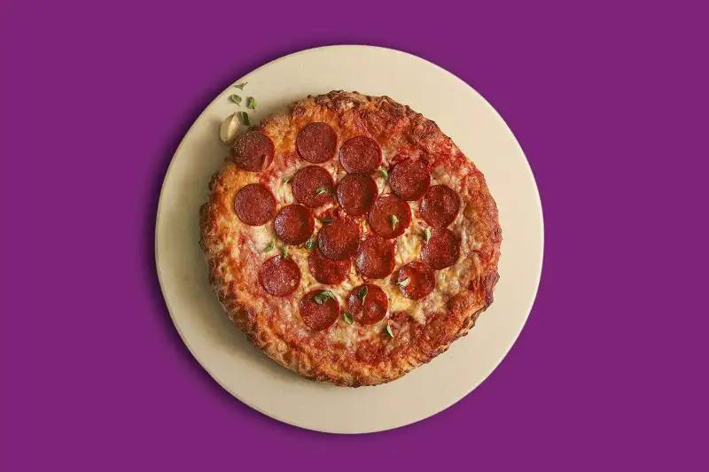 Baked Pizza on a stone, on a colored background