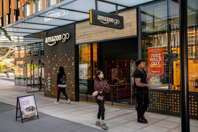 People walk by an Amazon Go store at the Amazon.com Inc. headquarters