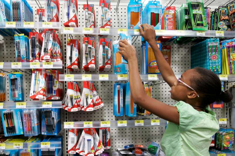 A young girl shopping for pencils at a school supply store