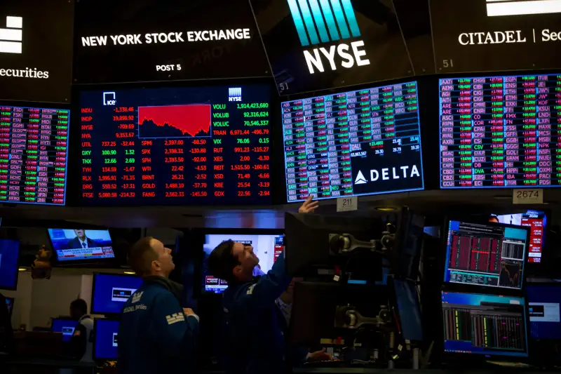 Traders work on the floor of the New York Stock Exchange in New York City.