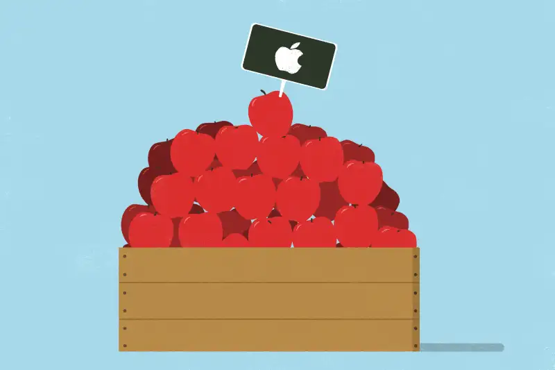 An apple wooden crate fills with apples, with apple stock logo stick on one of them.