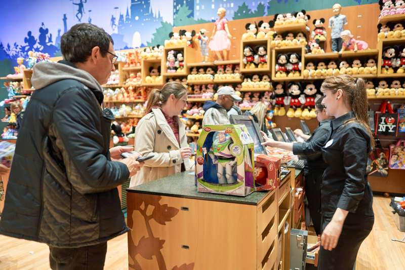 People purchasing multiple toys at a Disney store