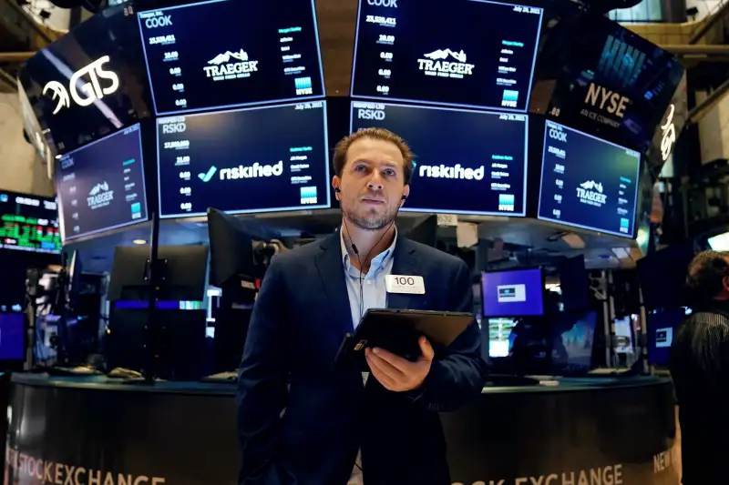 Traders work on the floor at the New York Stock Exchange in New York