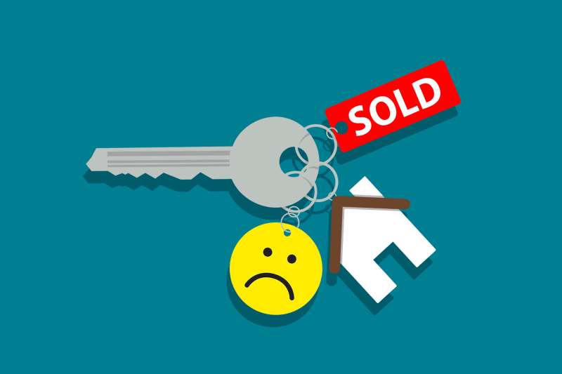 House keys with keychains that tell a story: Sold house, but buyer is sad/having doubts about it