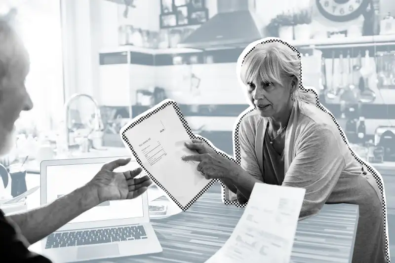 Senior couple doing home finances in their kitchen