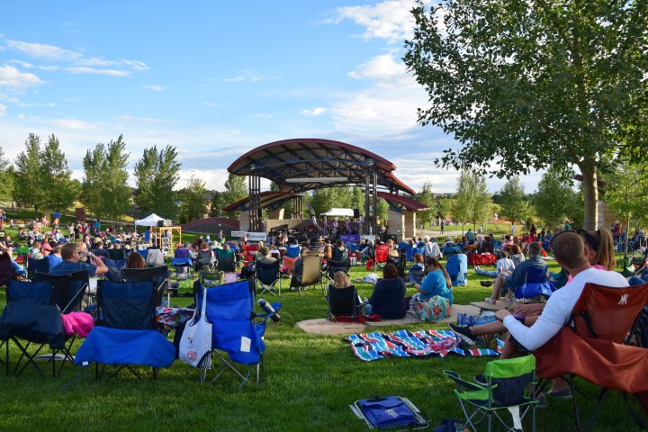 People enjoying the lawn at the local park and amphitheater in Centennial Colorado