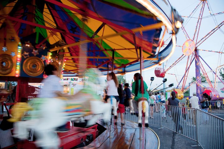 Kids enjoying a carrousel at a town fair in Overland Park, Kansas