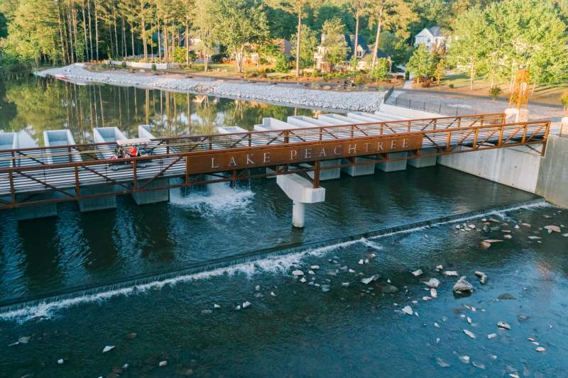 Aerial view of a golf cart crossing the bridge at Lake Peachtree in Georgia