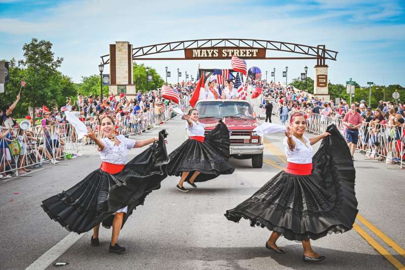 Dancers perform for a big crowd during the 4th of July street parade in Round Rock Texas