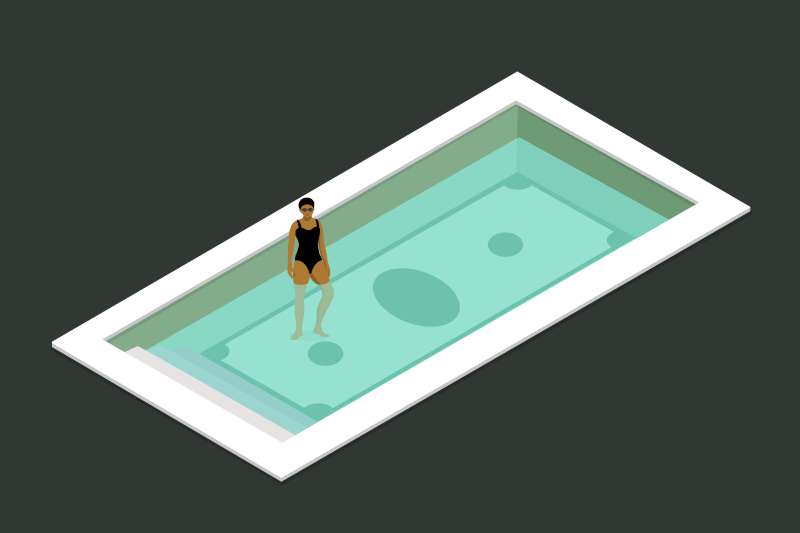A woman is standing in a pool with the image of money on the bottom, and it's not currently filled up all the way.