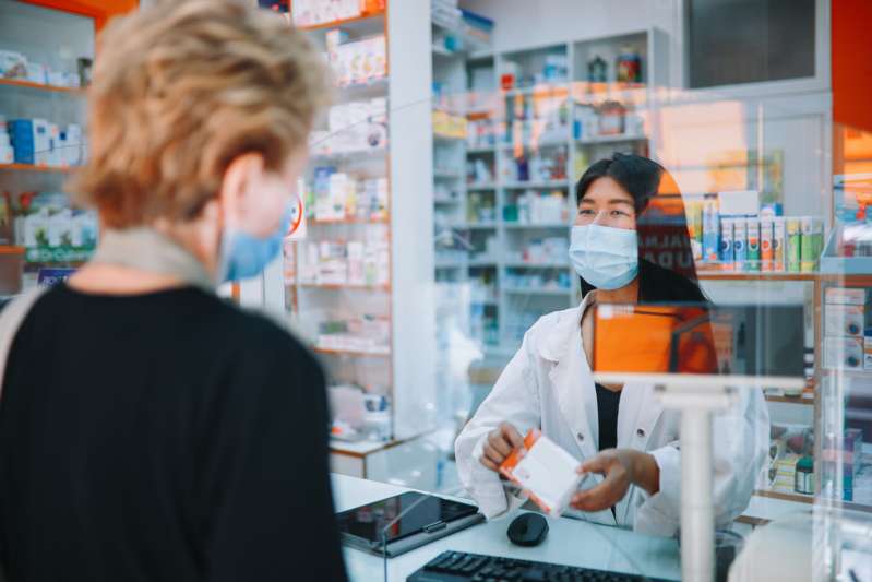 Customer buying medicine at a pharmacy register