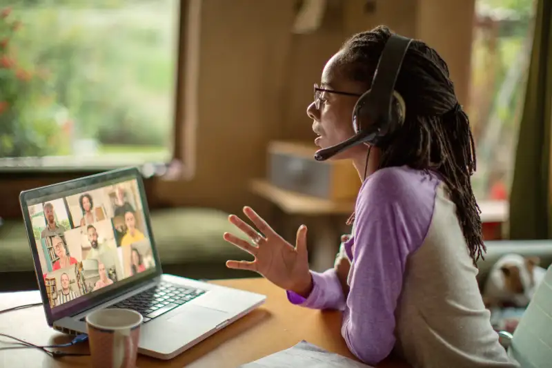 Woman in a digital meeting on her laptop, working from home