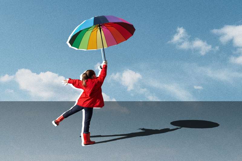 Collage of a little girl jumping with a multicolored umbrella on a blue sky background