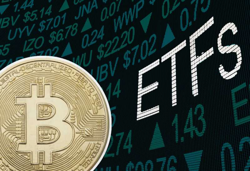 Large Bitcoin Over A Stock Exchange Screen With The Letters ETF