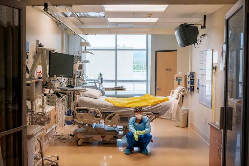 A nurse waits for her next patient at an emergency room.