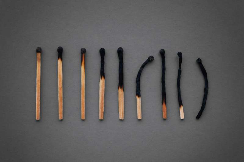 Photo of a row of burned out matches signifying the feeling of being burnt out after working