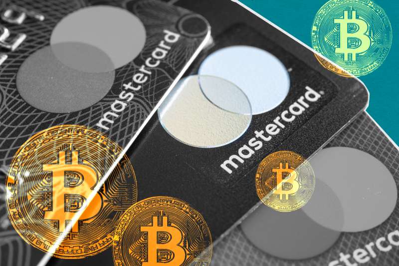 Photo of various Mastercard credit cards with many Bitcoin images superimposed.
