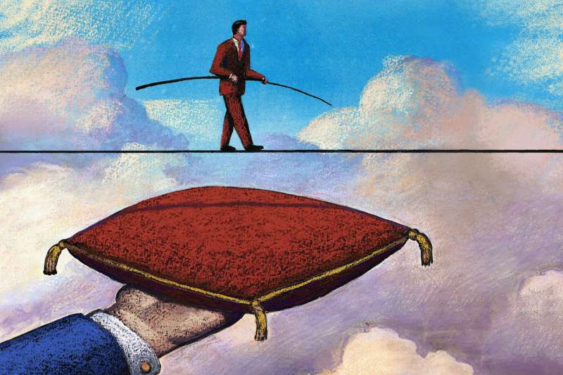 Illustration of a man crossing a tightrope high in the sky and a hand holding a pillow below in case he falls