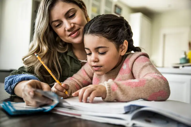 Mother helping out her daughter finish homework