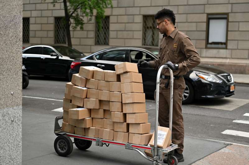 A UPS worker delivering many boxes