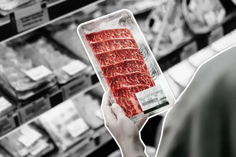 Person In A Grocery Store Holding A Meat Packet