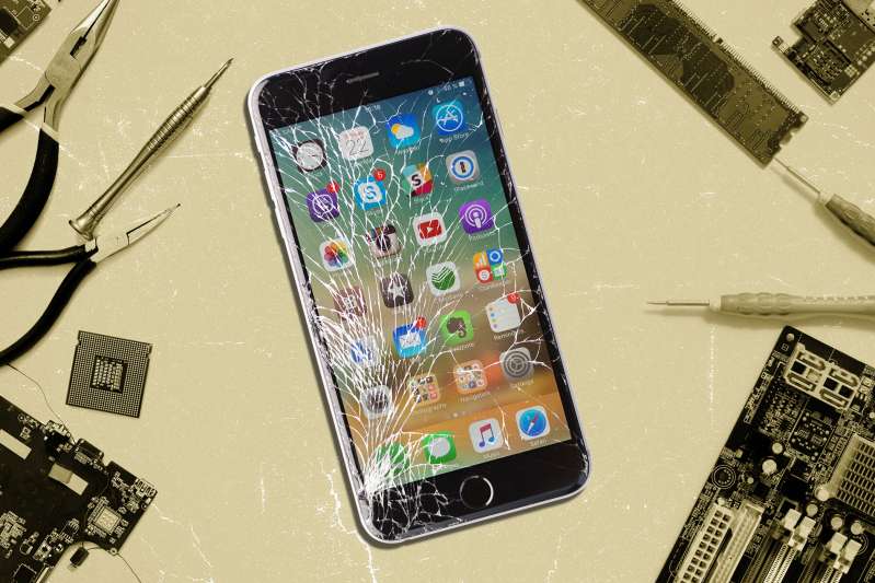 Broken iPhone screen surrounded by repair tools