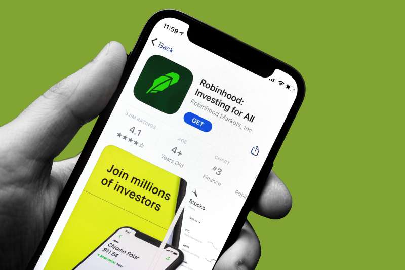 Close up of a hand holding a smart phone downloading the Robinhood Mobile app