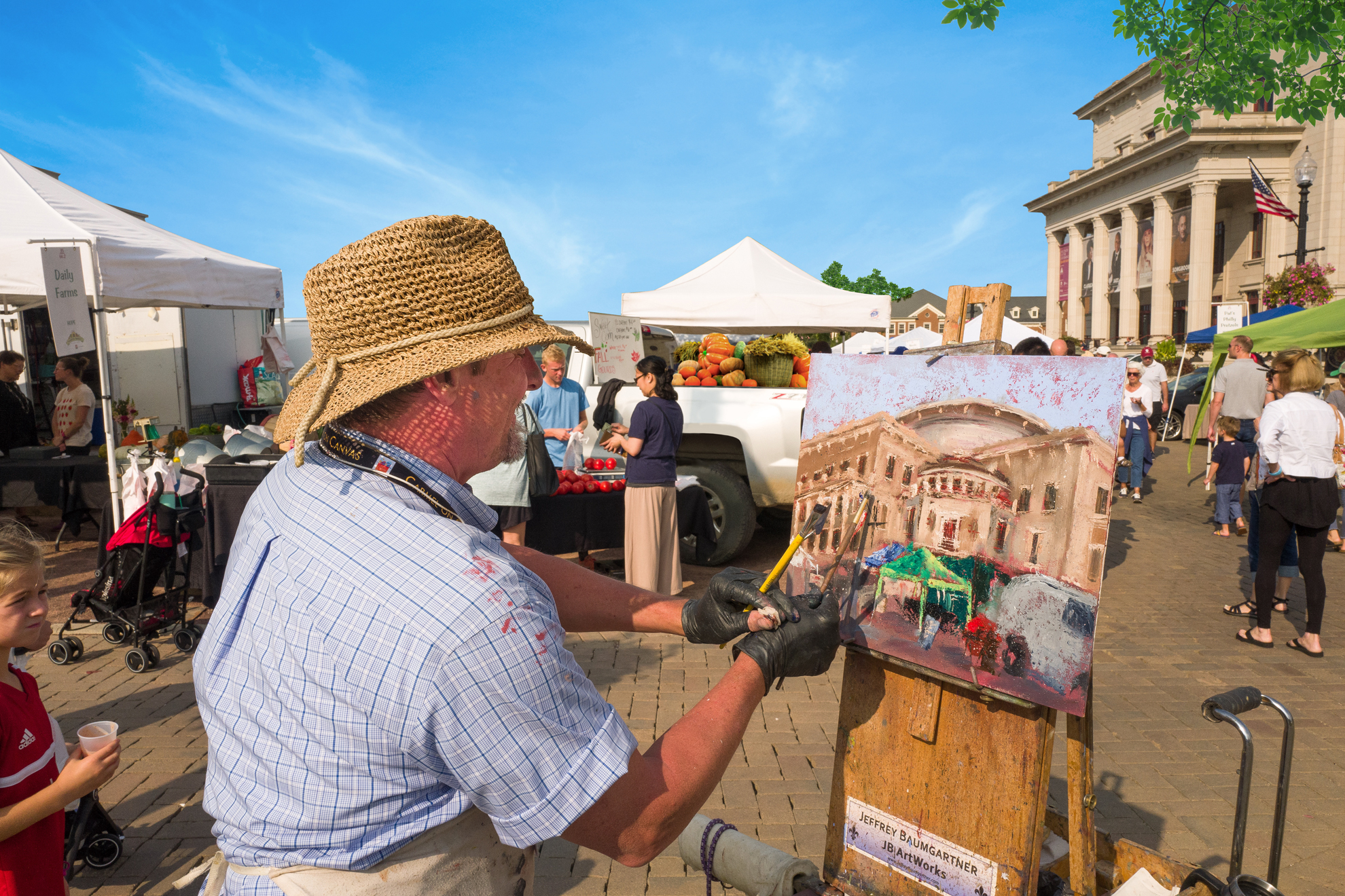 A man paints on an easel at the city square in Carmel Indiana