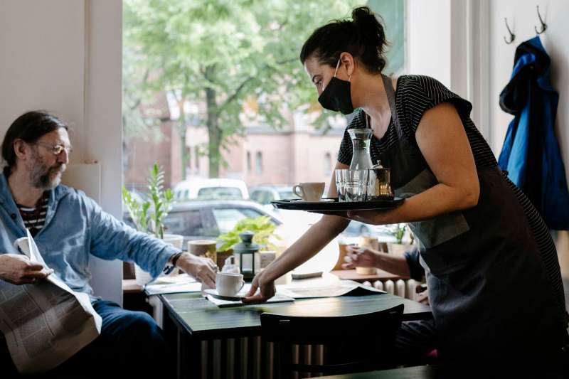 Waitress Handing Coffee To Customer