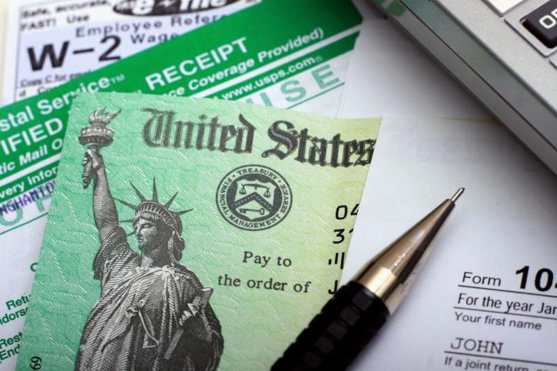 IRS tax forms alongside a tax refund check