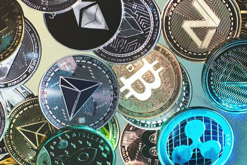 Close-up of multiple cryptocurrency coins including Bitcoin, Tron, Dash and Ethereum