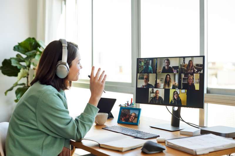 Businesswoman on a video call with her colleagues, working from home