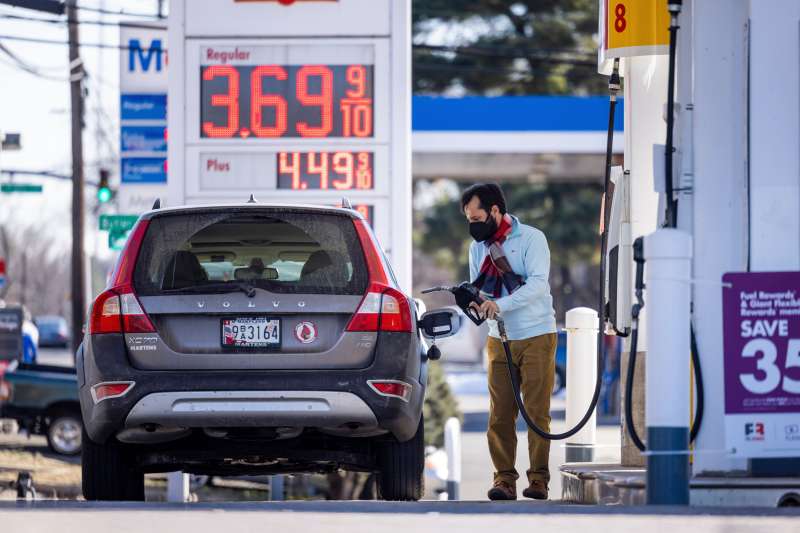 A man fils his car with fuel at a Shell gas station in Maryland, USA