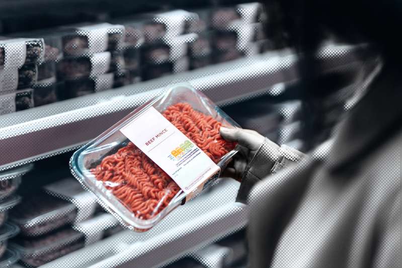 Woman shopping for meat at the supermarket