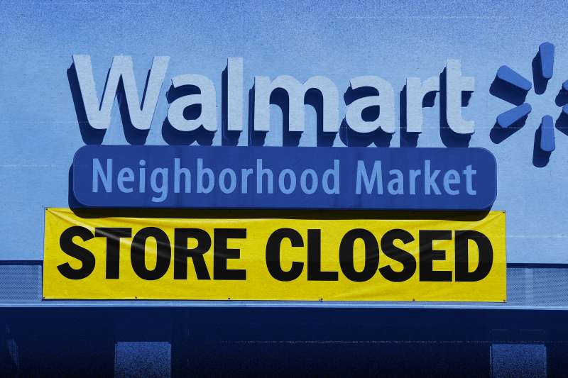 Walmart store front with a  STORE CLOSED  sign