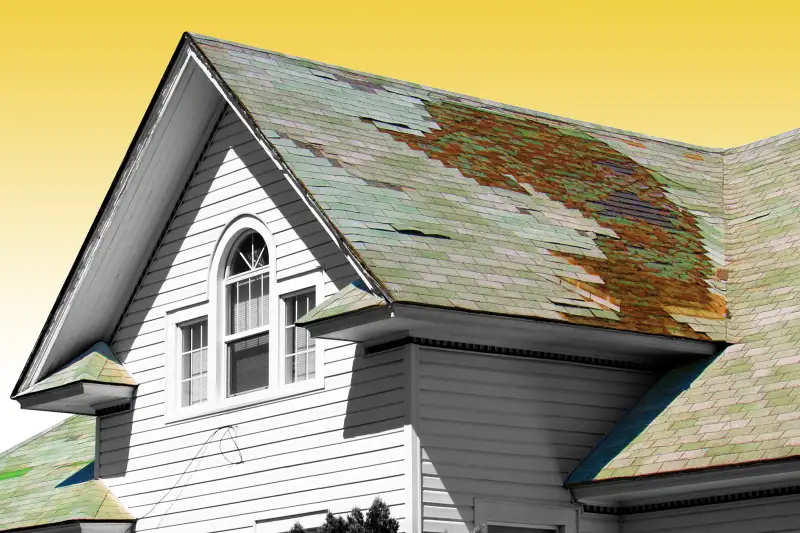 Close-up of a house with a damaged roof