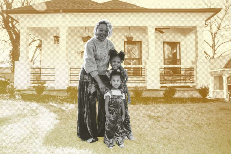 Portrait of a mother and two daughters standing in-front of their home.