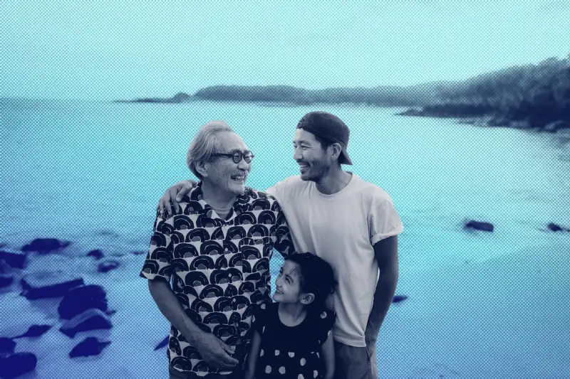 Grandfather, father and daughter having a good time on the beach