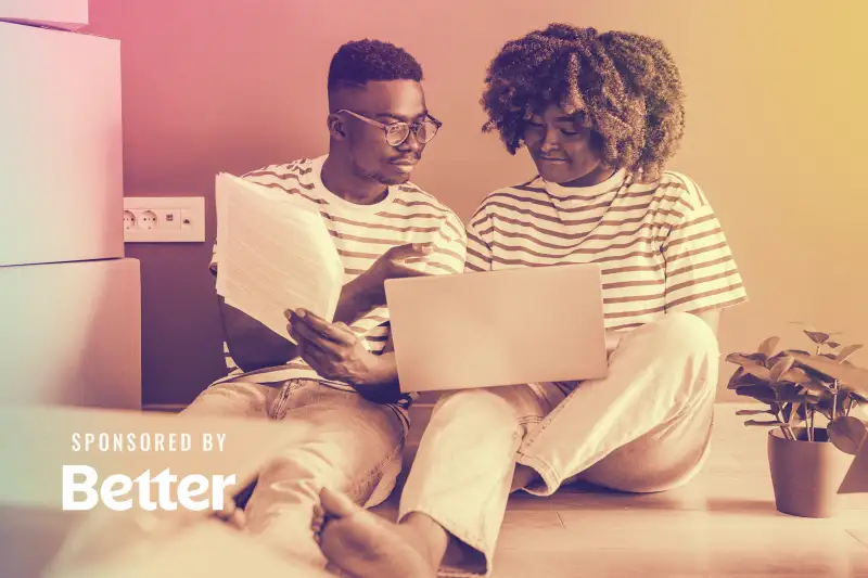 Couple sits with a laptop discussing a mortgage