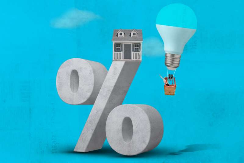 Oversized Percentage Symbol With Small House On Top And A Woman Inside A LightBulb Shaped Hot Air Balloon Trying To Reach It