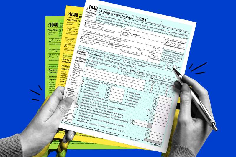 Close-up of a hand filling out a 2021 1040 Income Tax form