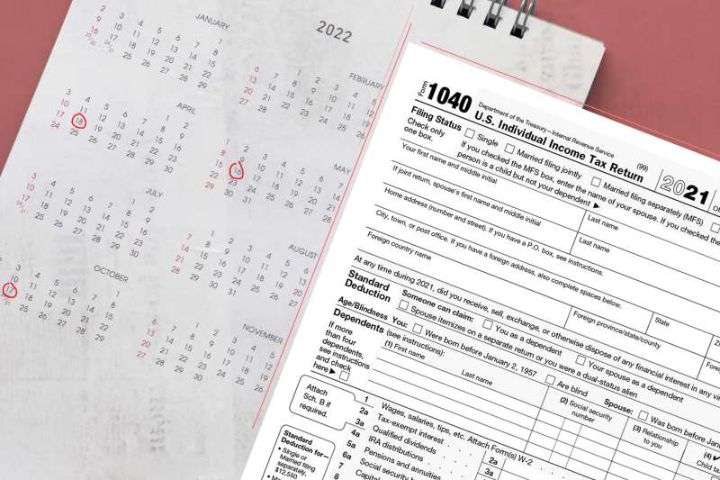 1040 Form In Front Of 2022 Calendar With Some Dates Marked