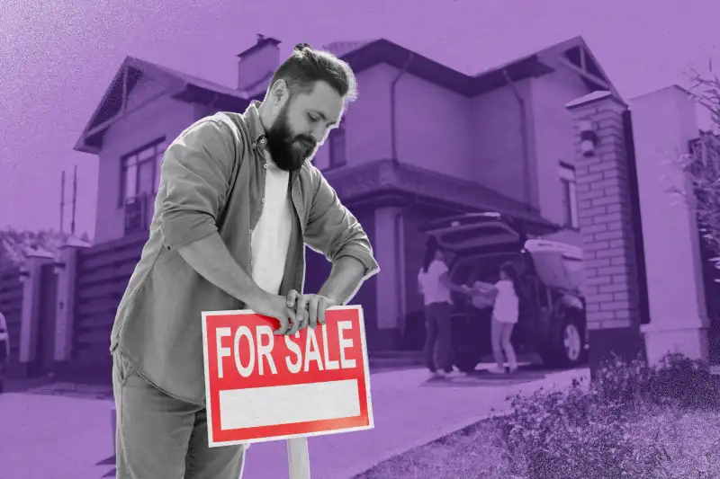 Young adult man puts up a  For Sale  sign outside his home