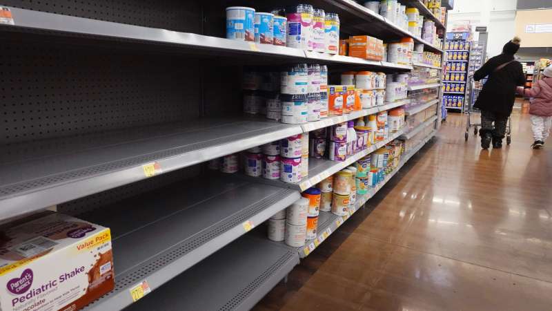 Editorial photo of an empty baby formula shelf in a supermarket store