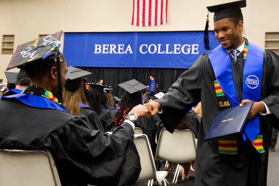 A student receives his diploma during a graduation ceremony at Berea College